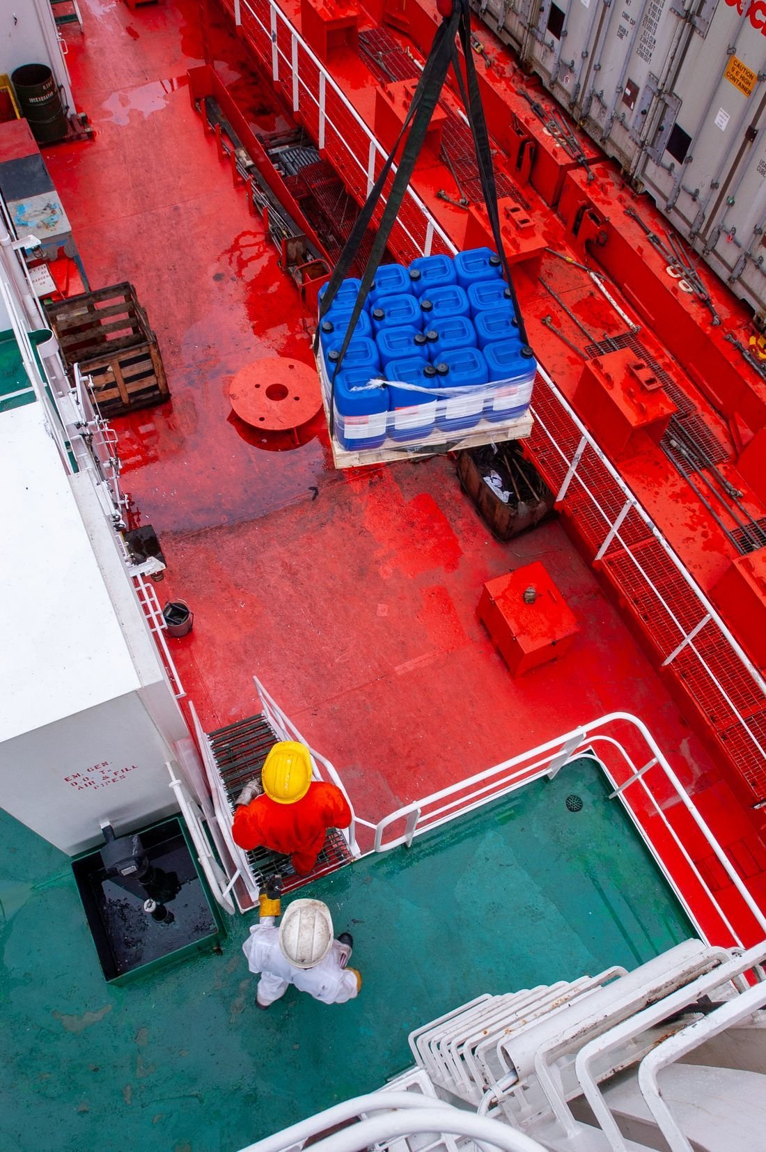 Crew loading stores onto a vessel's deck